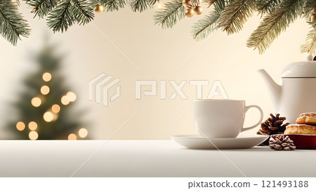 A cozy tea setting with a teacup, teapot, and fresh pastries, surrounded by warm lighting 121493188