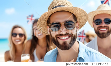 A group of friends in casual attire having a picnic by the beach, with Australian flags 121493344