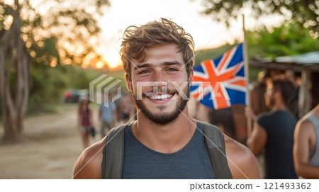A young man holding an Australian flag at a festival, surrounded by friends 121493362