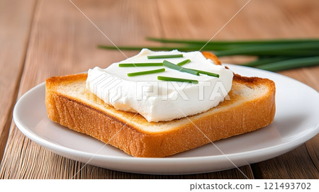 Quark spread on a slice of toasted bread with a garnish of fresh chives 121493702