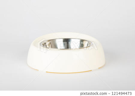 A clean, white background highlights an isolated pet bowl for cat and dog, featuring a circular metallic tray. The sleek design and metallic finish make feeding time fun and stylish. A clean, white background highlights an isolated pet bowl for cat and dog, featuring a circular metallic tray. The sleek design and metallic finish make feeding time fun and stylish. 121494473
