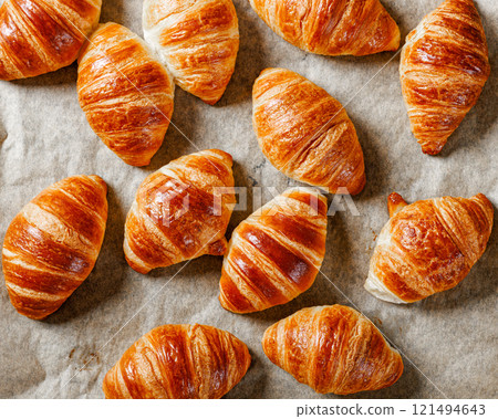 freshly baked in oven croissants on a sheet pan 121494643