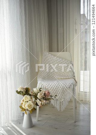 White leather chair with white knitted blanket White leather chair with white knitted blanket 121494664