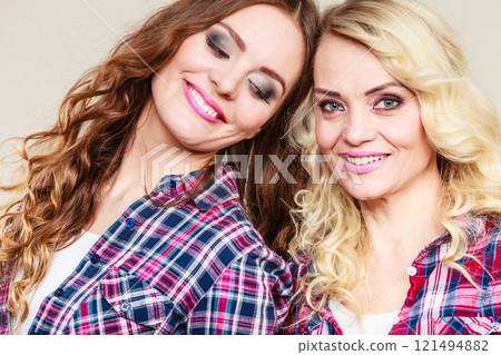 Portrait adult daughter with mother. 121494882