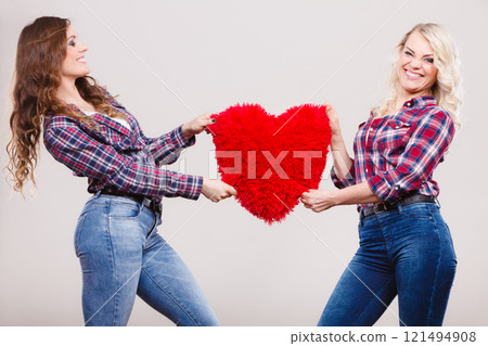 adult daughter and mother with heart love sign 121494908