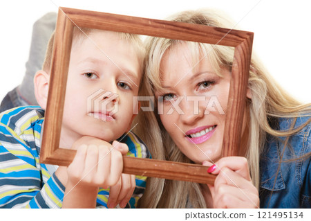 Portrait of mother and son holding photo frame Portrait of mother and son holding photo frame 121495134