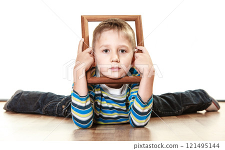 Little sad boy child framing his face 121495144