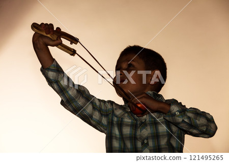 Kid holding slingshot in hands 121495265