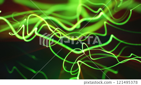 Bright neon green light trails curving and intersecting against a black futuristic backdrop 121495378