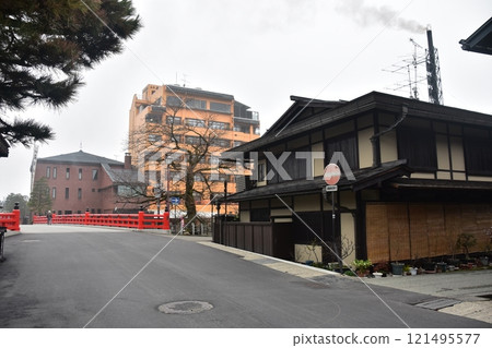Spring in Gifu Prefecture, Japan: Old streetscape in the center of Takayama city, tourist attraction Nakabashi Bridge, historic Japanese houses and magnificent pine trees 121495577
