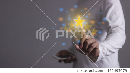 Excellence Review Young Man with smart phone mobile hand touching five star to review and give 5star Excellence Review Young Man with smart phone mobile hand touching five star to review and give 5star 121495679