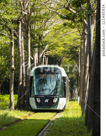 The circular light rail train drives past the Kaohsiung Museum of Fine Arts station in Taiwan. 121495934