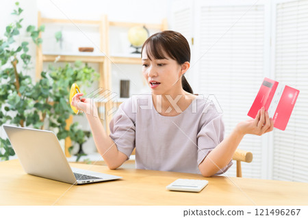 Middle-aged woman, bankbook, worries 121496267