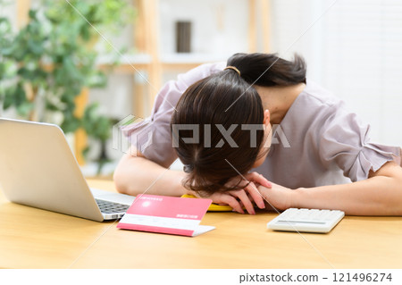 Middle-aged woman, bankbook, worries 121496274