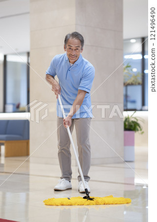 Building cleaning image: A male cleaning staff in his 60s smiling at the camera 121496490