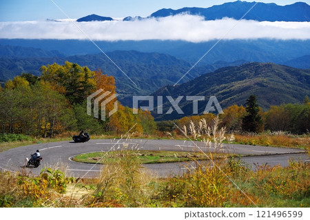 Two bikes riding the hairpin curves of the Mitake Skyline in autumn 121496599