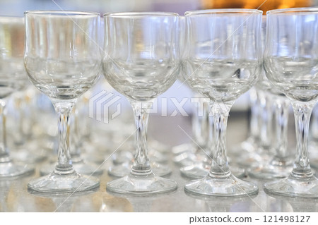 A row of empty, clear, clean wine glasses. Close-up with space to copy. High quality photo 121498127