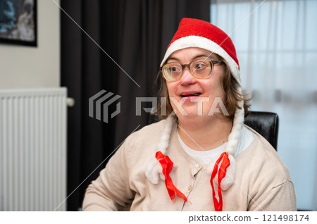 Cosy moment with a 42 yo woman with Down Syndrome, celebrating Christmas at home, Belgium 121498174