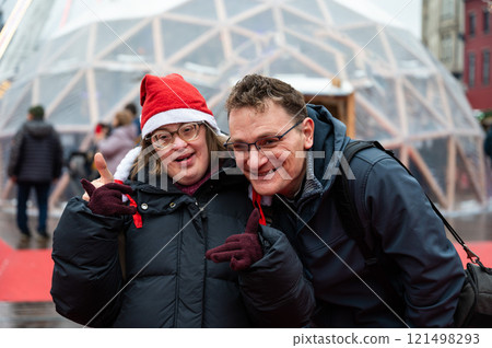 42 yo Down Syndrome woman and her 45 yo brother at the Christmas market in Brussels, Belgium 121498293