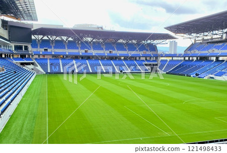 A view of the soccer stadium on a sunny day from the first floor 121498433