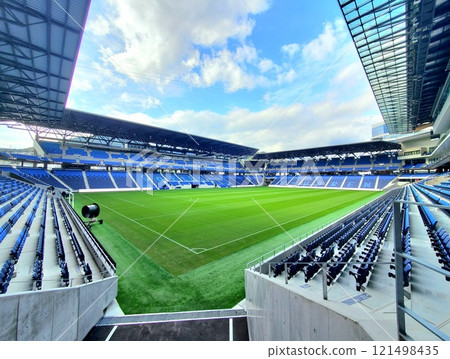 A view of the soccer stadium on a sunny day from above the entrance gate A view of the soccer stadium on a sunny day from above the entrance gate 121498435