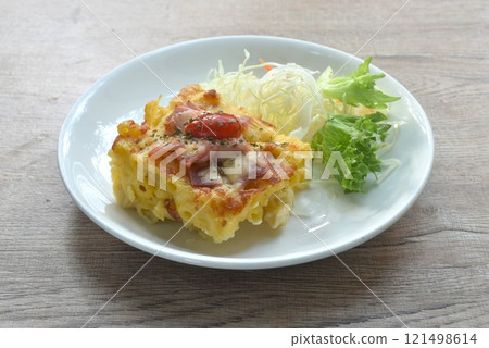 baking macaroni and slice pork bacon with chees topping tomato eat couple salad on plate 121498614
