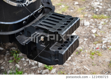 Close-up of a tractor weight on rugged terrain. Close-up of a tractor weight on rugged terrain. 121498723