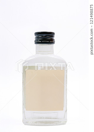 a small glass bottle with a clear liquid. a small bottle of Russian vodka a small glass bottle with a clear liquid. a small bottle of Russian vodka 121498875