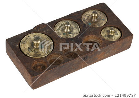 Vintage wooden box with scale weights set on white 121499757