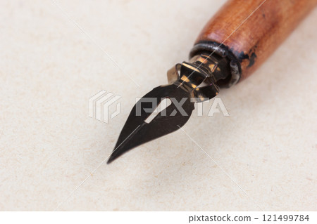 Fountain pen on an antique textured paper. 121499784