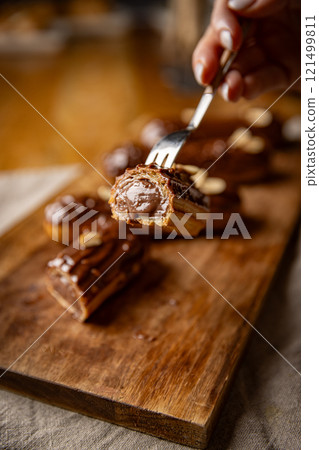 Freshly made chocolate eclairs 121499811