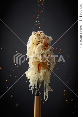 Traditional German sauerkraut with spices on a fork. 121499880
