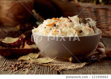 Traditional German sauerkraut on a old rustic wooden table. Traditional German sauerkraut on a old rustic wooden table. 121499881