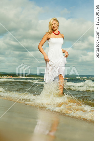 Beautiful blonde girl on beach, summertime Beautiful blonde girl on beach, summertime 121500569