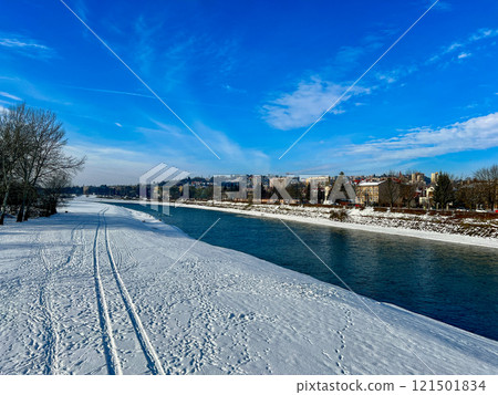 Panoramic winter landscape view with the blue sky on the banks of the San river at Przemysl, Poland  121501834