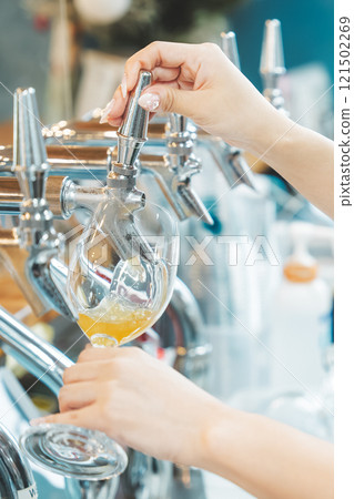 A female clerk pouring beer from a dispenser. Photo courtesy of Tsukioka Brewery. A female clerk pouring beer from a dispenser. Photo courtesy of Tsukioka Brewery. 121502269