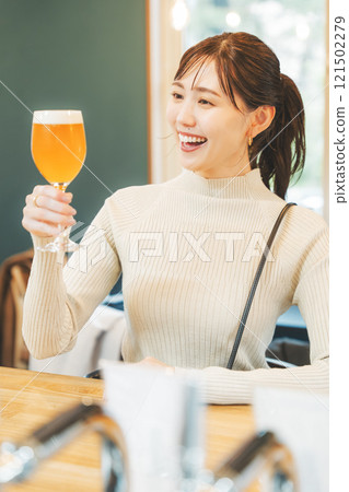 A young woman enjoying craft beer. Photo courtesy of Tsukioka Brewery. A young woman enjoying craft beer. Photo courtesy of Tsukioka Brewery. 121502279