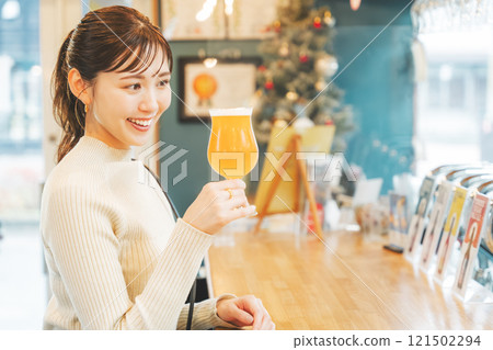 A young woman enjoying craft beer. Photo courtesy of Tsukioka Brewery. 121502294
