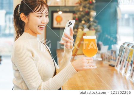 A young woman enjoying craft beer. Photo courtesy of Tsukioka Brewery. A young woman enjoying craft beer. Photo courtesy of Tsukioka Brewery. 121502296