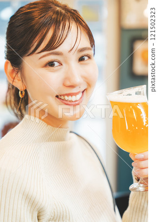 A young woman enjoying craft beer. Photo courtesy of Tsukioka Brewery. A young woman enjoying craft beer. Photo courtesy of Tsukioka Brewery. 121502323