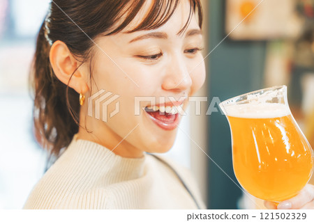 A young woman enjoying craft beer. Photo courtesy of Tsukioka Brewery. A young woman enjoying craft beer. Photo courtesy of Tsukioka Brewery. 121502329