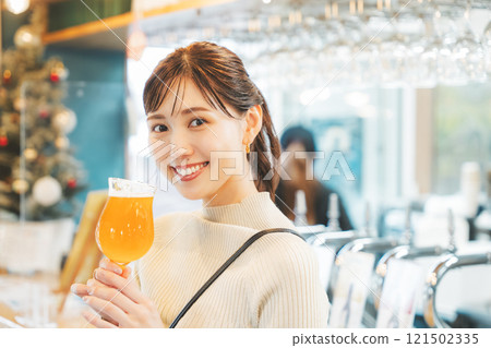 A young woman enjoying craft beer. Photo courtesy of Tsukioka Brewery. 121502335