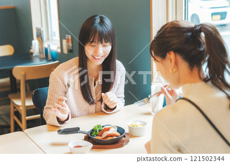 Two young women toasting with beer. Photo courtesy of Tsukioka Brewery. 121502344