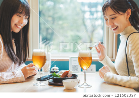 Two young women toasting with beer. Photo courtesy of Tsukioka Brewery. 121502357