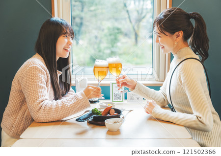 Two young women toasting with beer. Photo courtesy of Tsukioka Brewery. 121502366