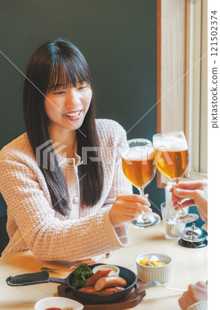 Two young women toasting with beer. Photo courtesy of Tsukioka Brewery. 121502374