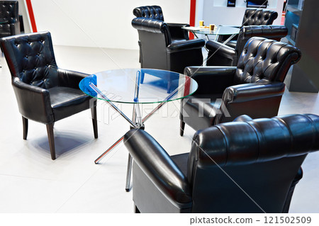 Glass table and black leather armchairs for meeting 121502509