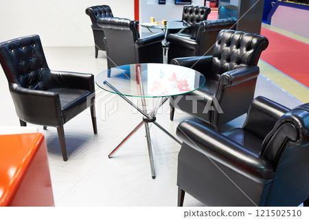 Glass table and black leather armchairs for meeting 121502510