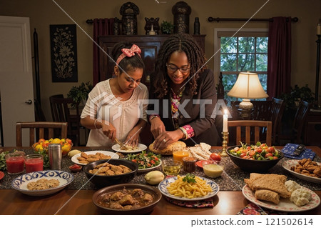 Portrait of African American mother and daughter preparing festive traditional dishes together in cozy home copy space 121502614