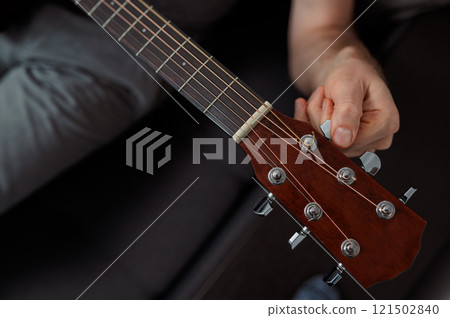 Guitarist on acoustic guitar playing melody in studio. Close up musician instrument Guitarist on acoustic guitar playing melody in studio. Close up musician instrument 121502840